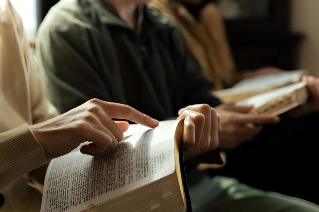 A Christian group praying to God with the bible and sharing the gospel
