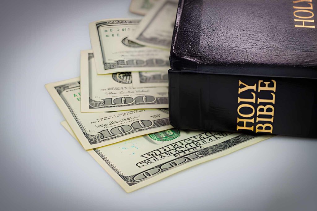 Holy Bible and money. Hundred dollars (Image: iStockphoto)