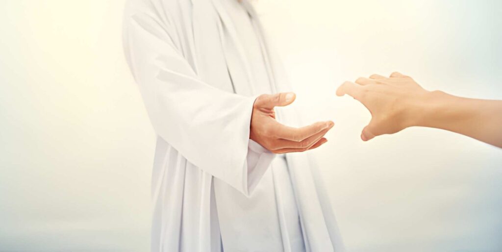 A man standing with his hand outstretched toward a follower 