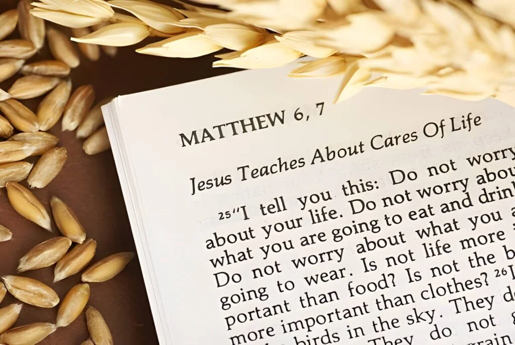 An open Bible with grain around it on a brown background