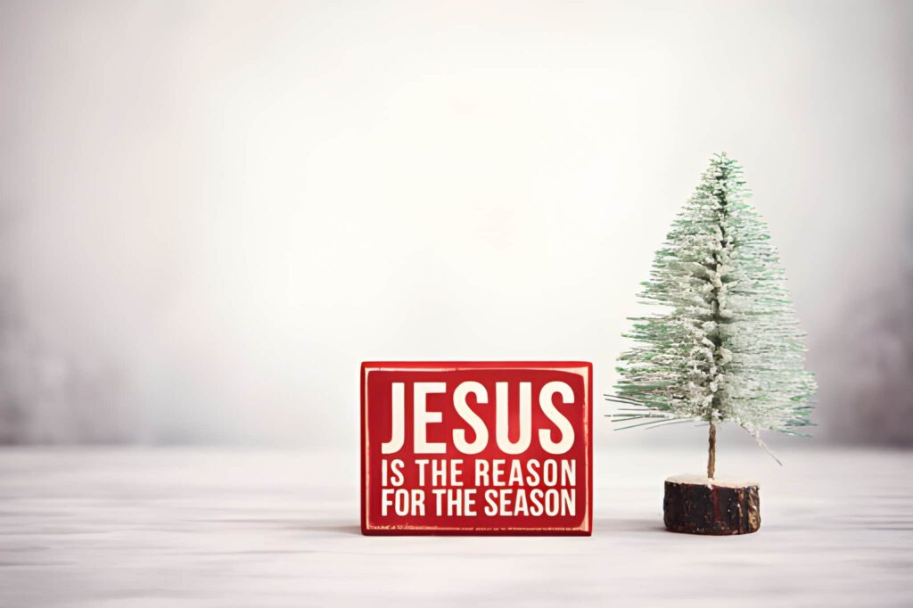 Christmas Background with Christmas Tree and Jesus is the Reason for the season Sign